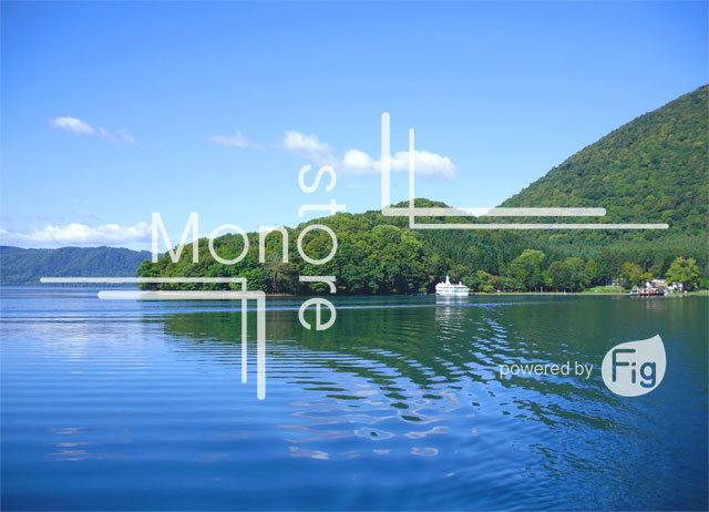 Photograph of water reflected the blue sky and mountains